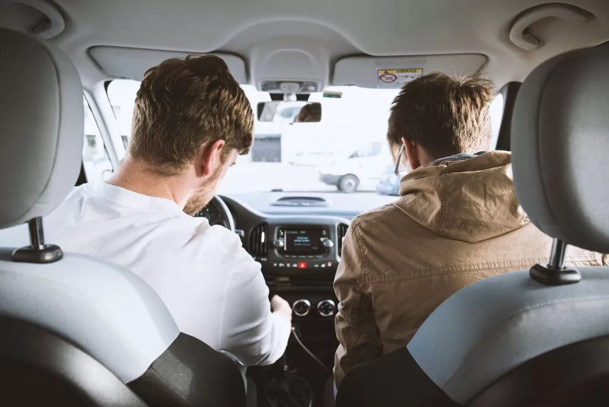 Deux homme assis à l'avant d'une voiture